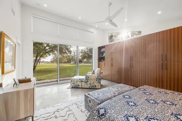 a bed room with a bed and a large window