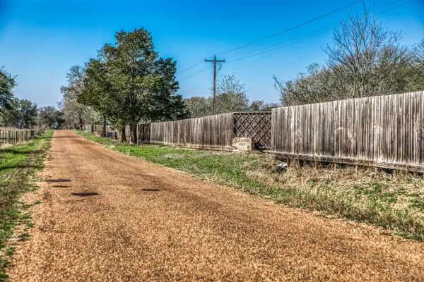 a view of backyard with wooden fence