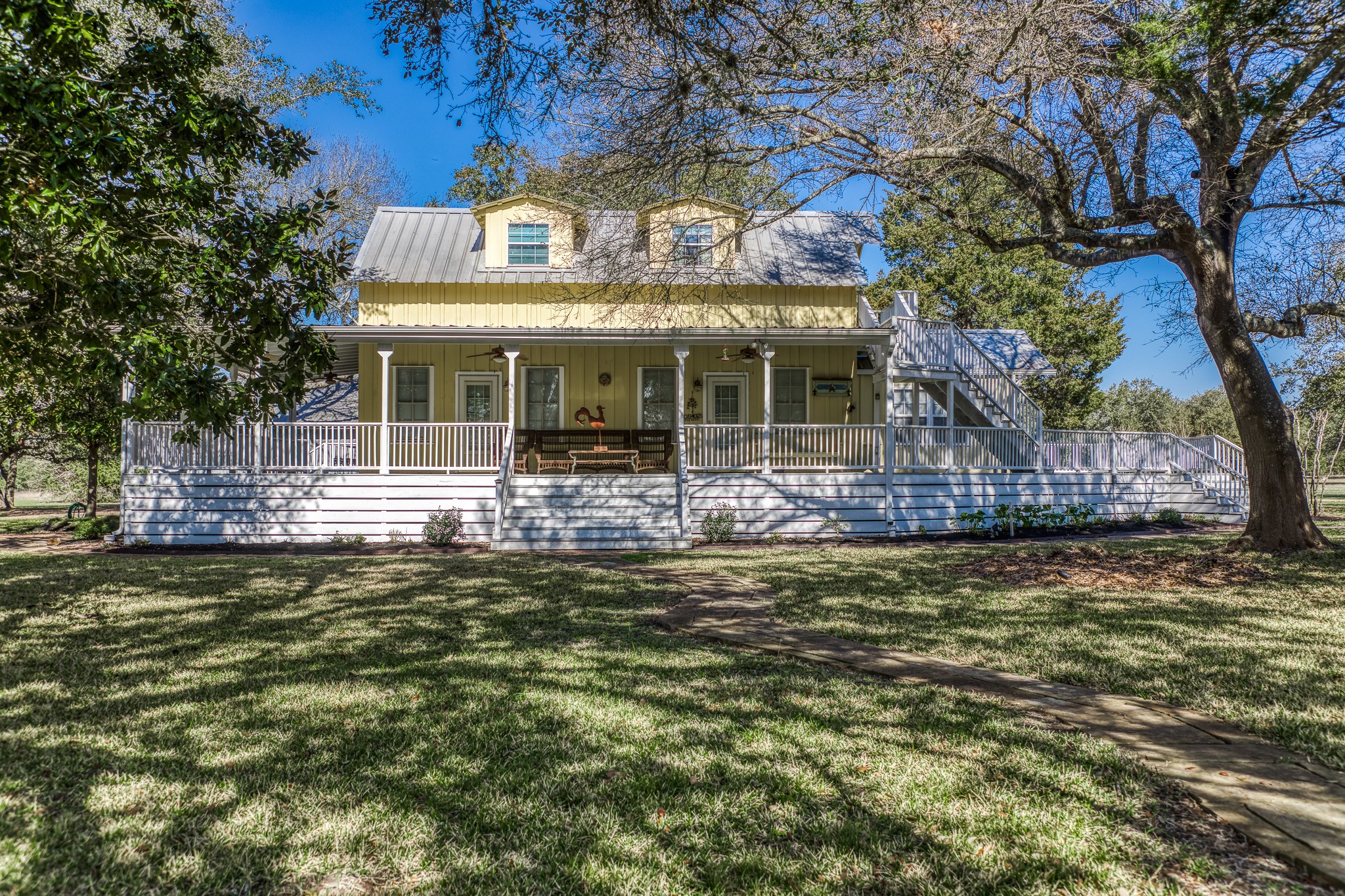 1585 Round Top Road Round Top, TX 78954 - Photo 8 of 30 a front view of a house with a yard