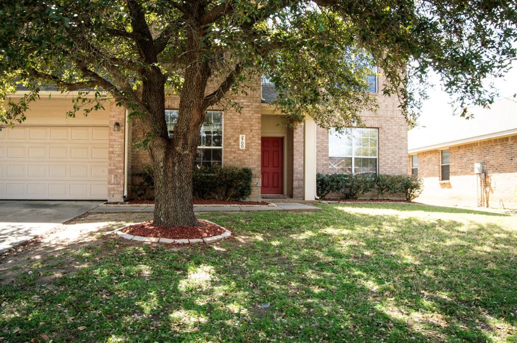 2700 Hereford Road Denton, TX 76210 - Photo 1 of 38 View of property hidden behind natural elements with a front yard, brick siding, and concrete driveway