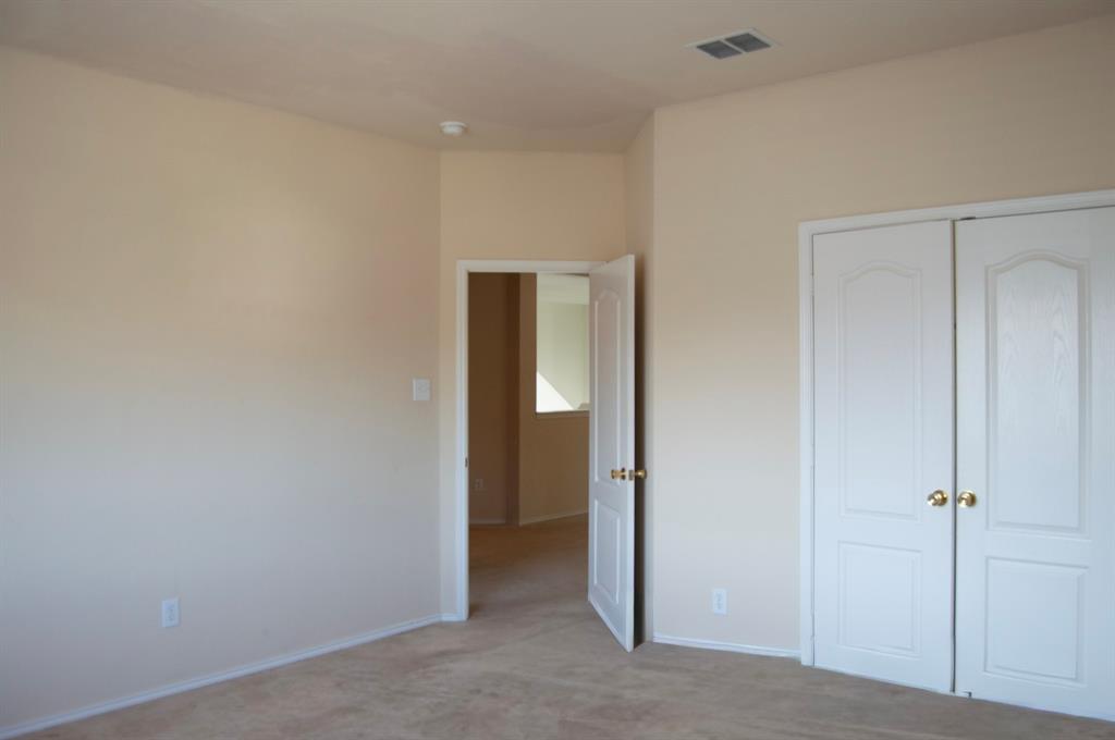 2700 Hereford Road Denton, TX 76210 - Photo 16 of 38 Unfurnished bedroom featuring light carpet and a closet
