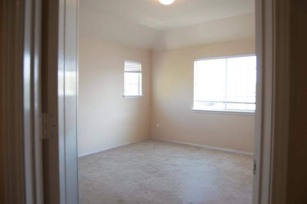 2700 Hereford Road Denton, TX 76210 - Photo 17 of 38 Unfurnished room featuring lofted ceiling and baseboards