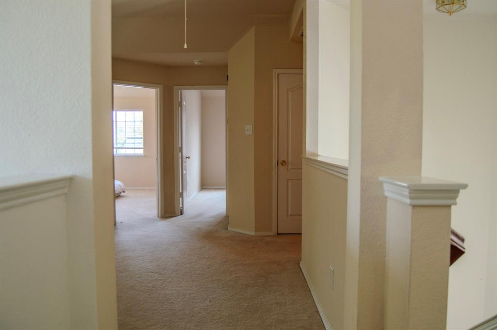2700 Hereford Road Denton, TX 76210 - Photo 23 of 38 Hallway featuring light colored carpet and an upstairs landing