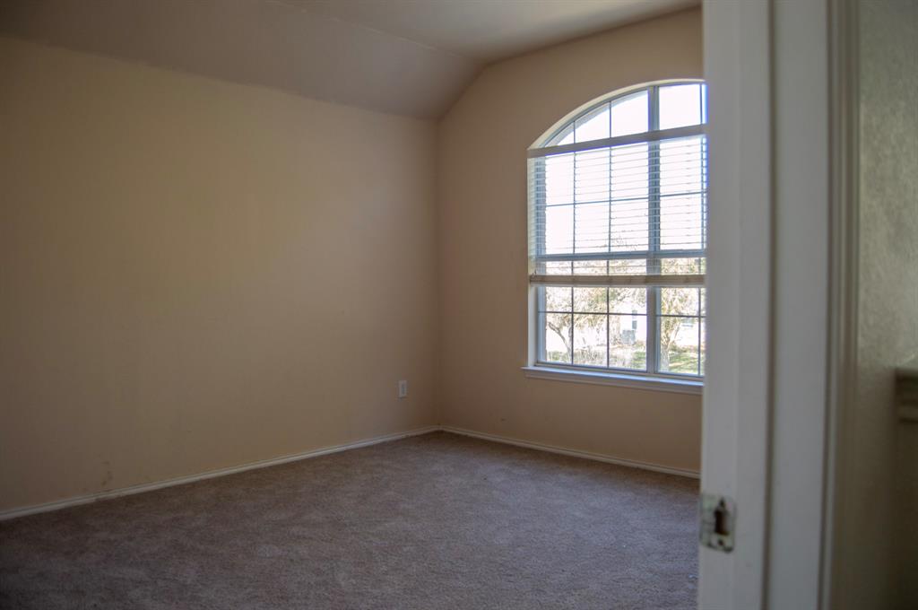 2700 Hereford Road Denton, TX 76210 - Photo 29 of 38 Empty room featuring carpet floors and vaulted ceiling