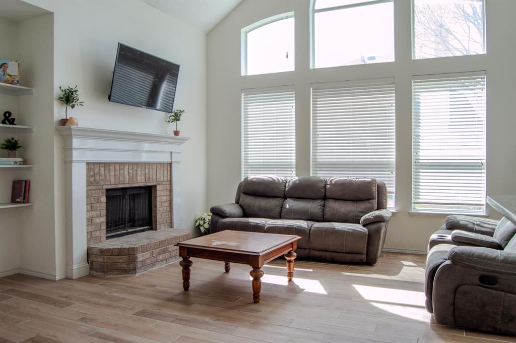 2700 Hereford Road Denton, TX 76210 - Photo 32 of 38 Living area featuring a brick fireplace, lofted ceiling, and light wood-style floors