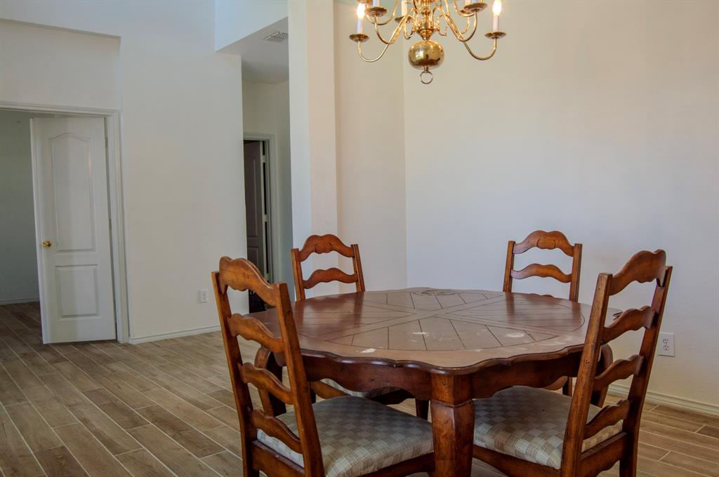 2700 Hereford Road Denton, TX 76210 - Photo 6 of 38 Dining area with hanging lights and wood tiled floors