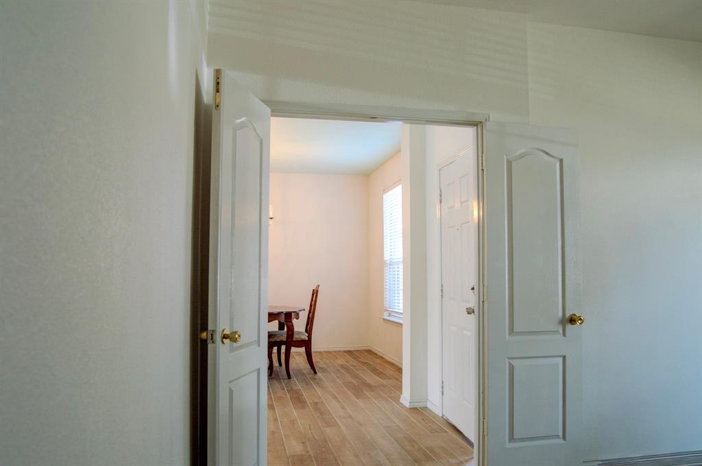 2700 Hereford Road Denton, TX 76210 - Photo 7 of 38 Hallway featuring light wood-style floors and baseboards