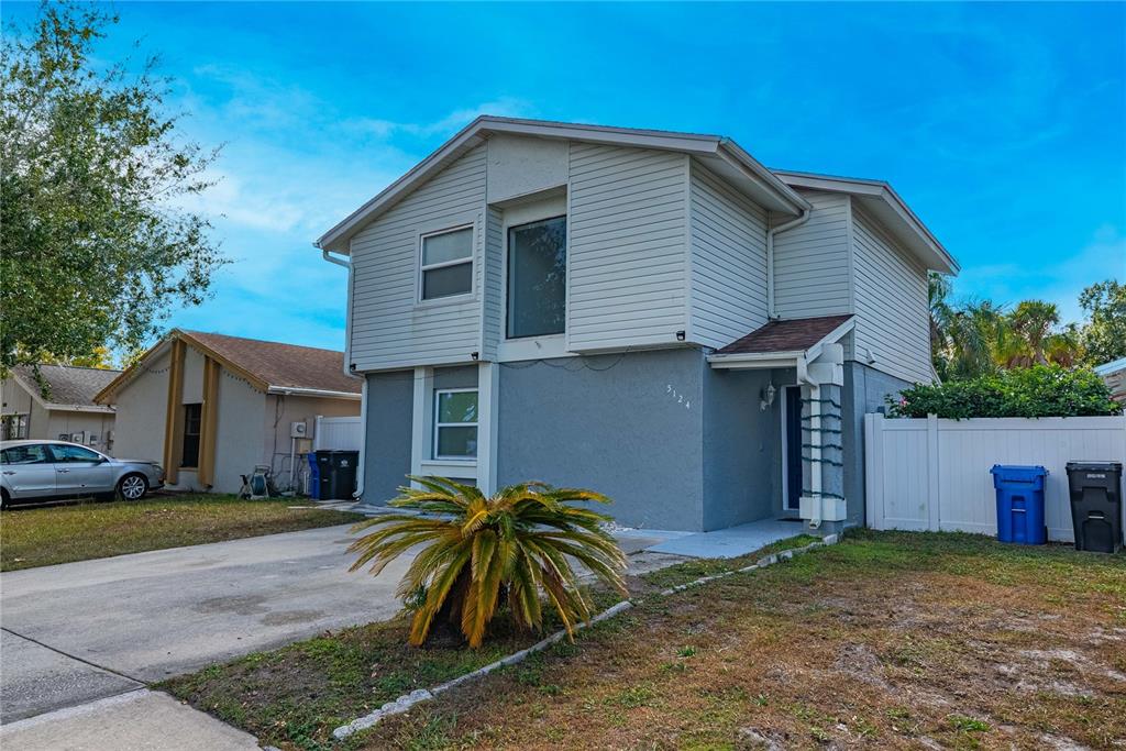 5124 Springwood Drive Tampa, FL 33624 - Photo 1 of 53 a front view of house with yard and trees around