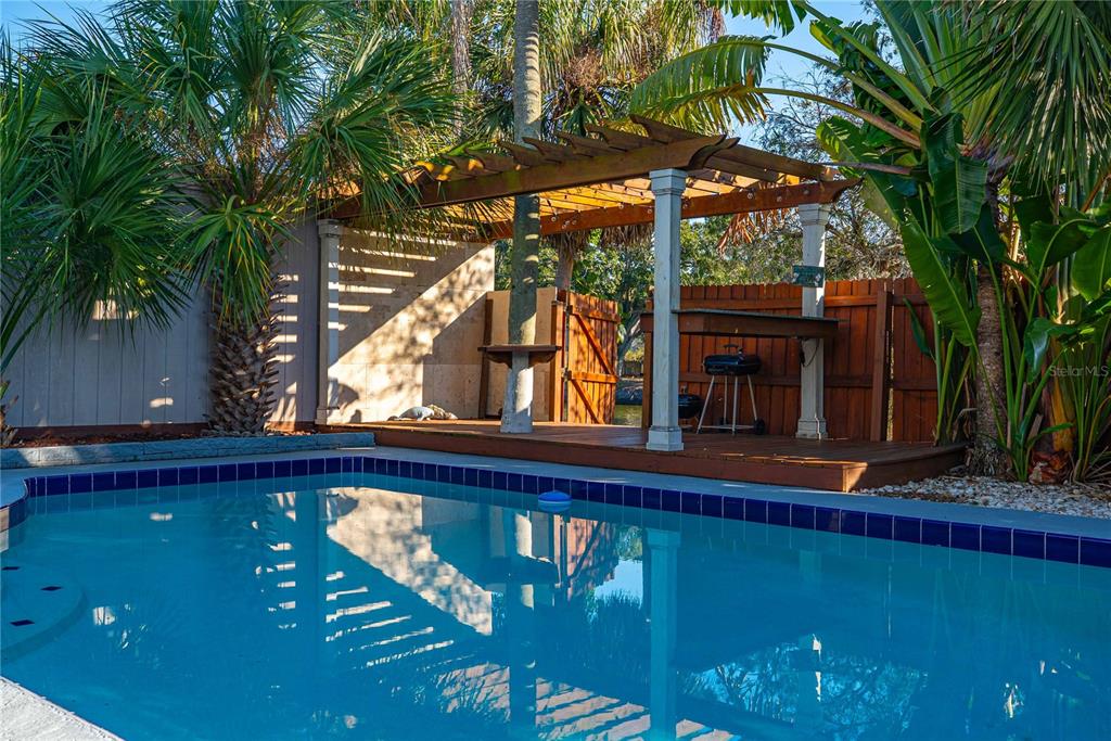 5124 Springwood Drive Tampa, FL 33624 - Photo 11 of 53 a wooden bench sitting in front of a building