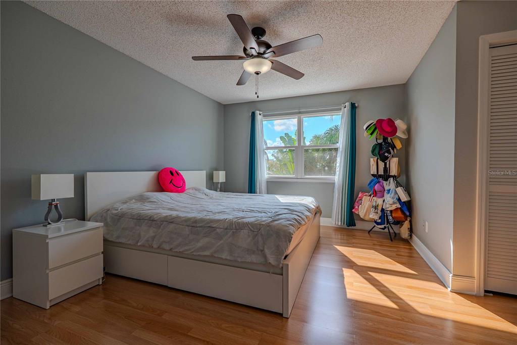 5124 Springwood Drive Tampa, FL 33624 - Photo 29 of 53 a bed room with a bed and a ceiling fan