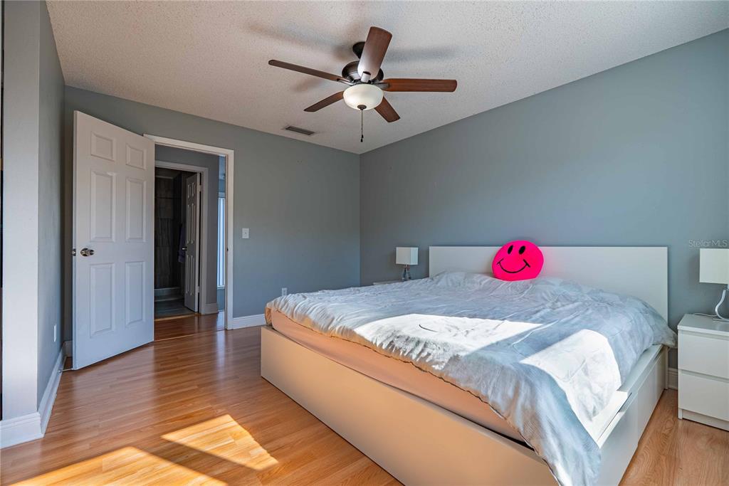 5124 Springwood Drive Tampa, FL 33624 - Photo 31 of 53 a bedroom with a bed and a chandelier