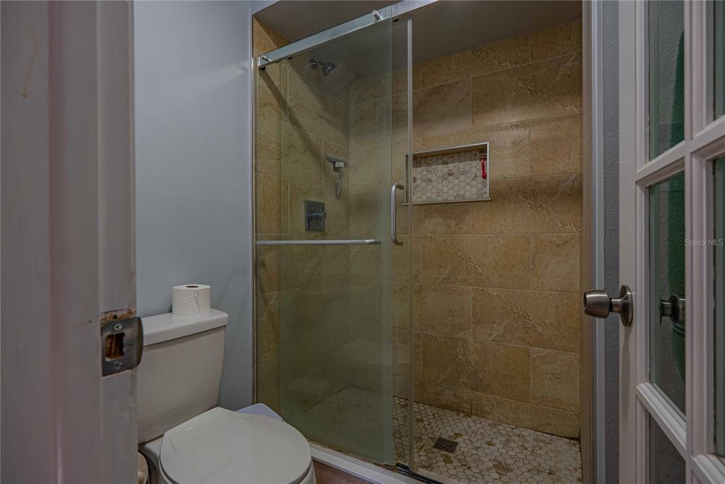 5124 Springwood Drive Tampa, FL 33624 - Photo 34 of 53 a bathroom with a shower and toilet