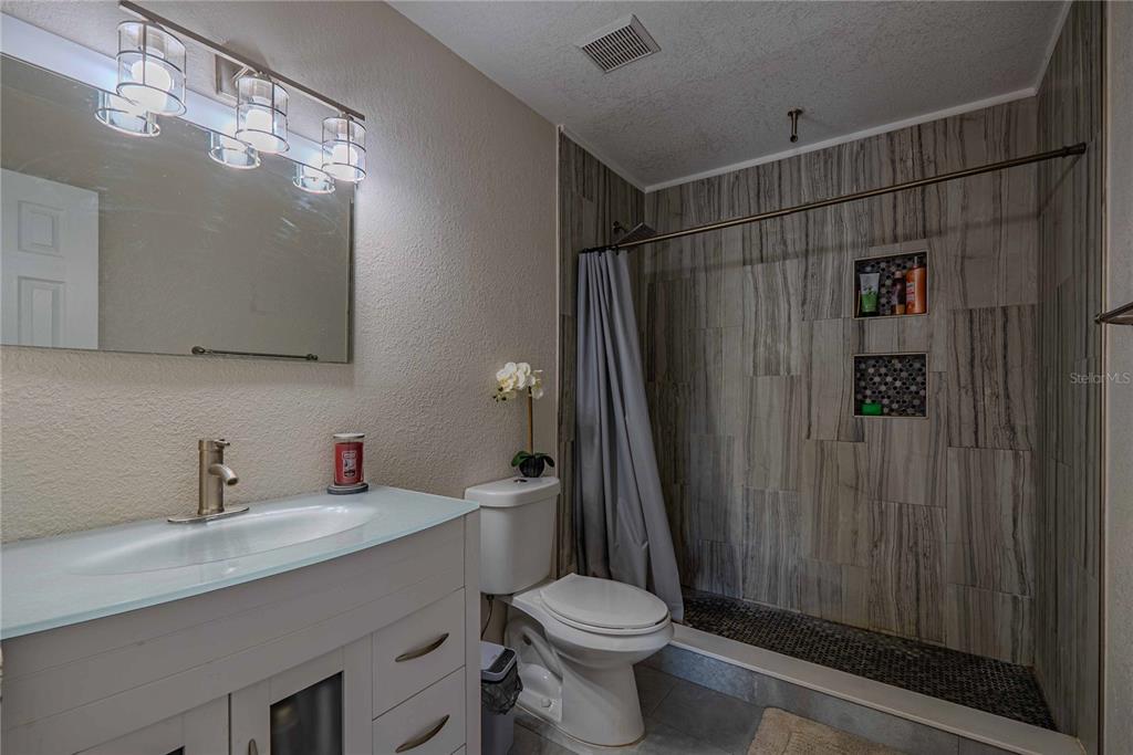 5124 Springwood Drive Tampa, FL 33624 - Photo 38 of 53 a bathroom with a sink toilet and shower
