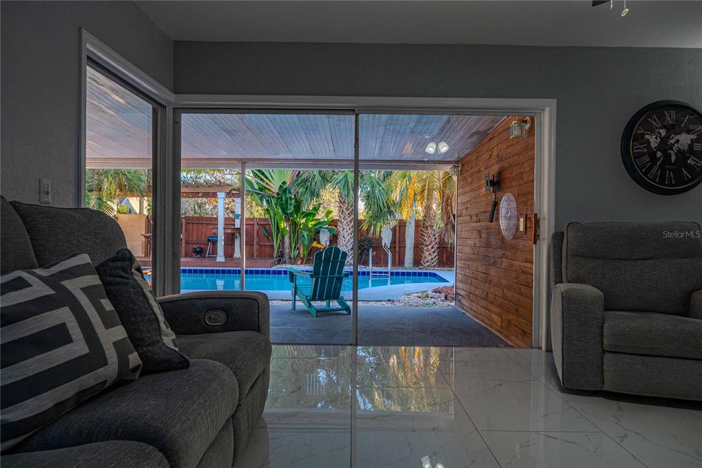 5124 Springwood Drive Tampa, FL 33624 - Photo 4 of 53 a living room with furniture and a large window