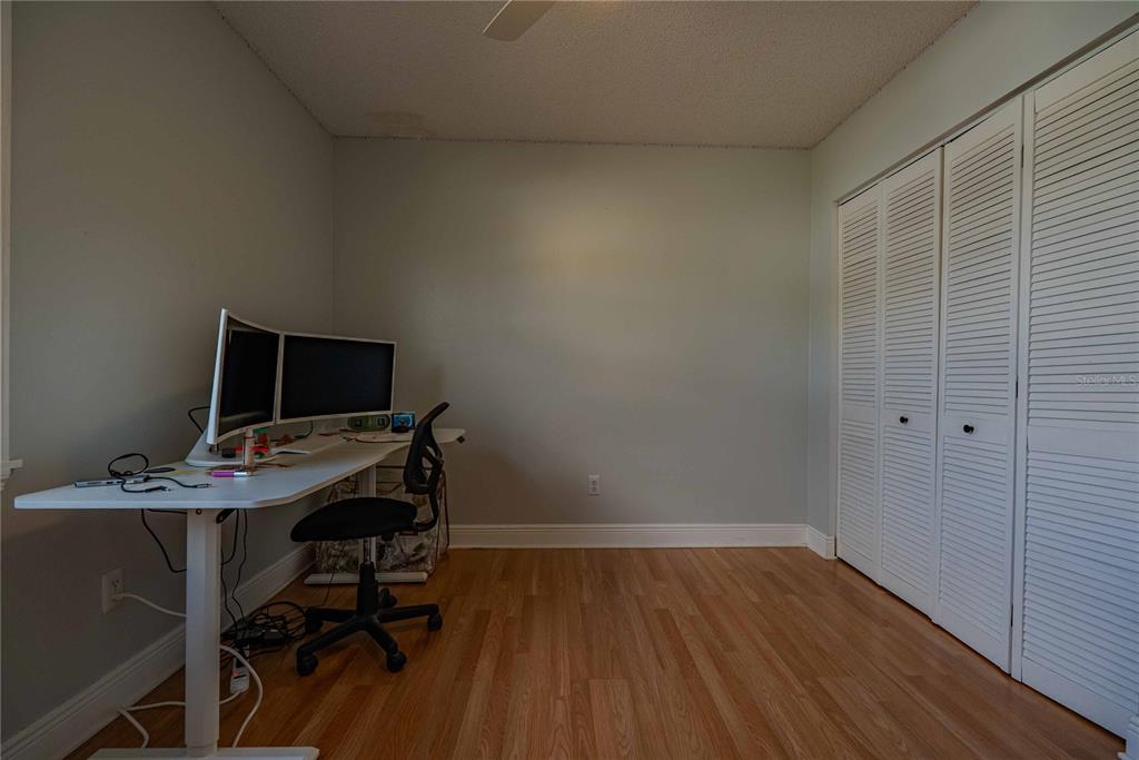 5124 Springwood Drive Tampa, FL 33624 - Photo 42 of 53 a view of a workspace with furniture and wooden floor
