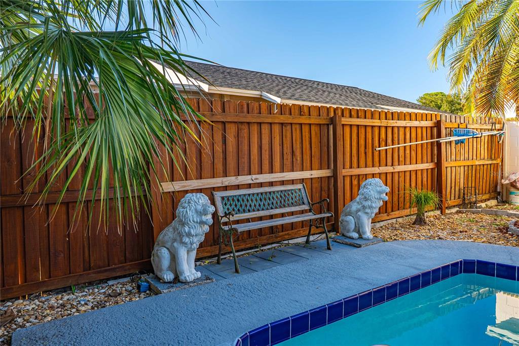 5124 Springwood Drive Tampa, FL 33624 - Photo 8 of 53 a view of a backyard with a chair and potted plants