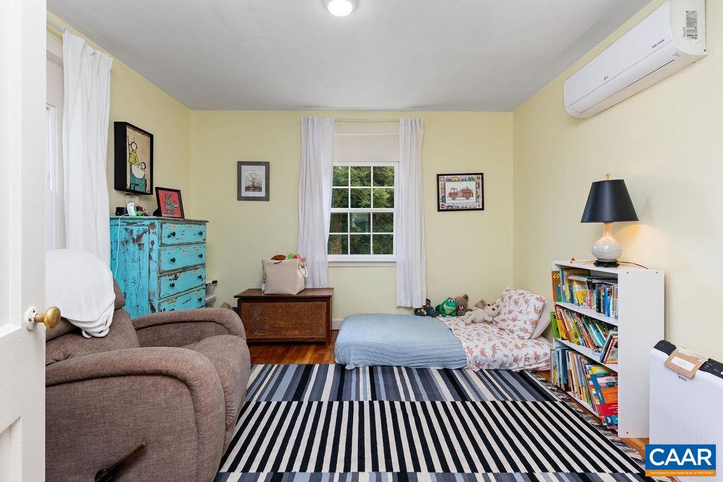 1002 2nd Street Southeast Charlottesville, VA 22902 - Photo 13 of 29 a living room with furniture and a book shelf