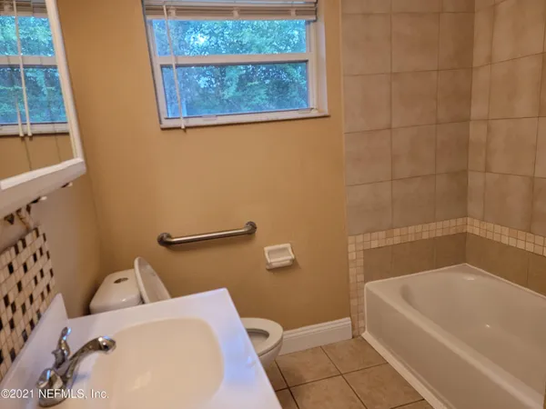 a bathroom with a bathtub and toilet