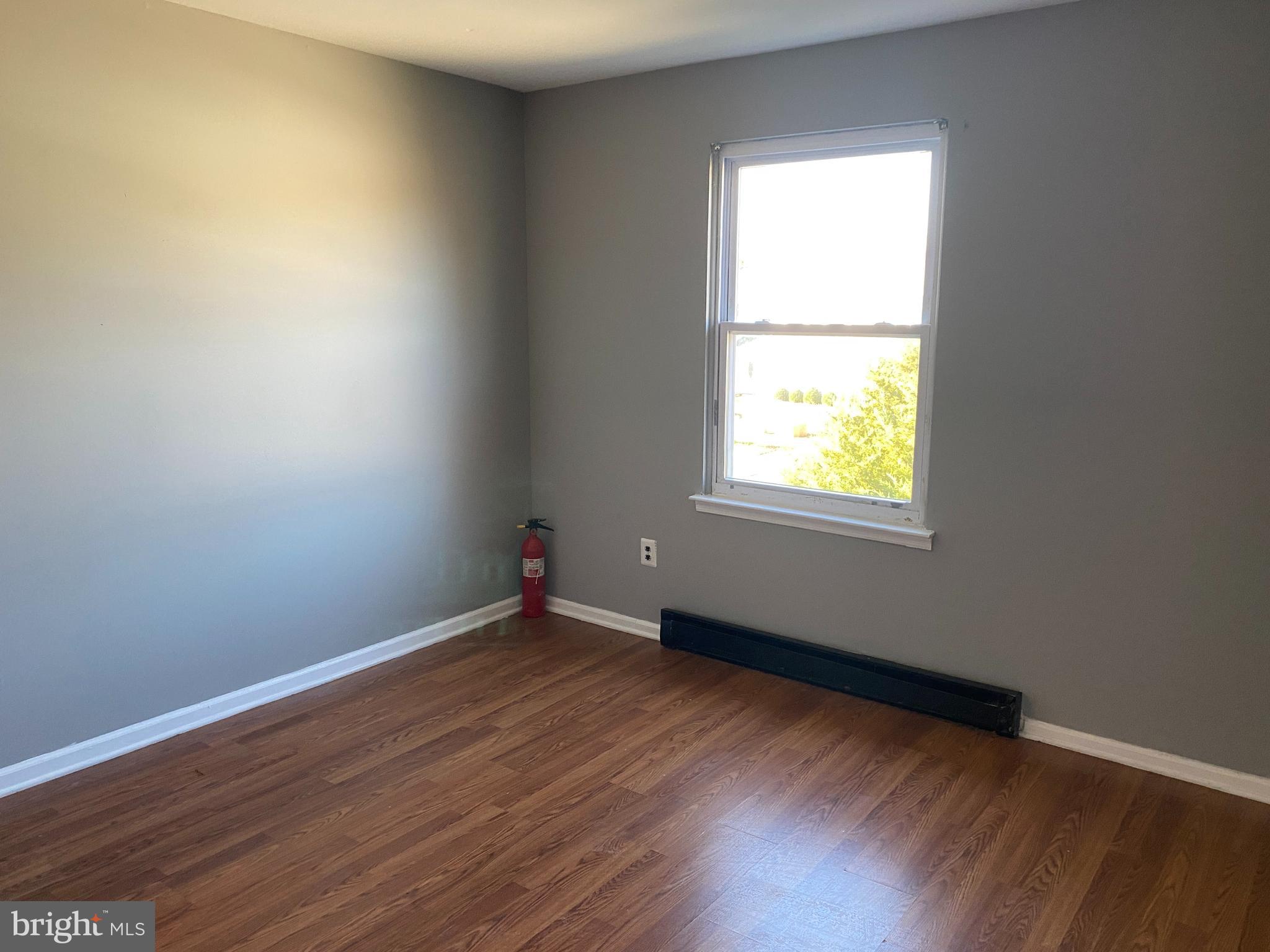 14 Berkshire Road Sicklerville, NJ 08081 - Photo 13 of 17 an empty room with wooden floor and a window