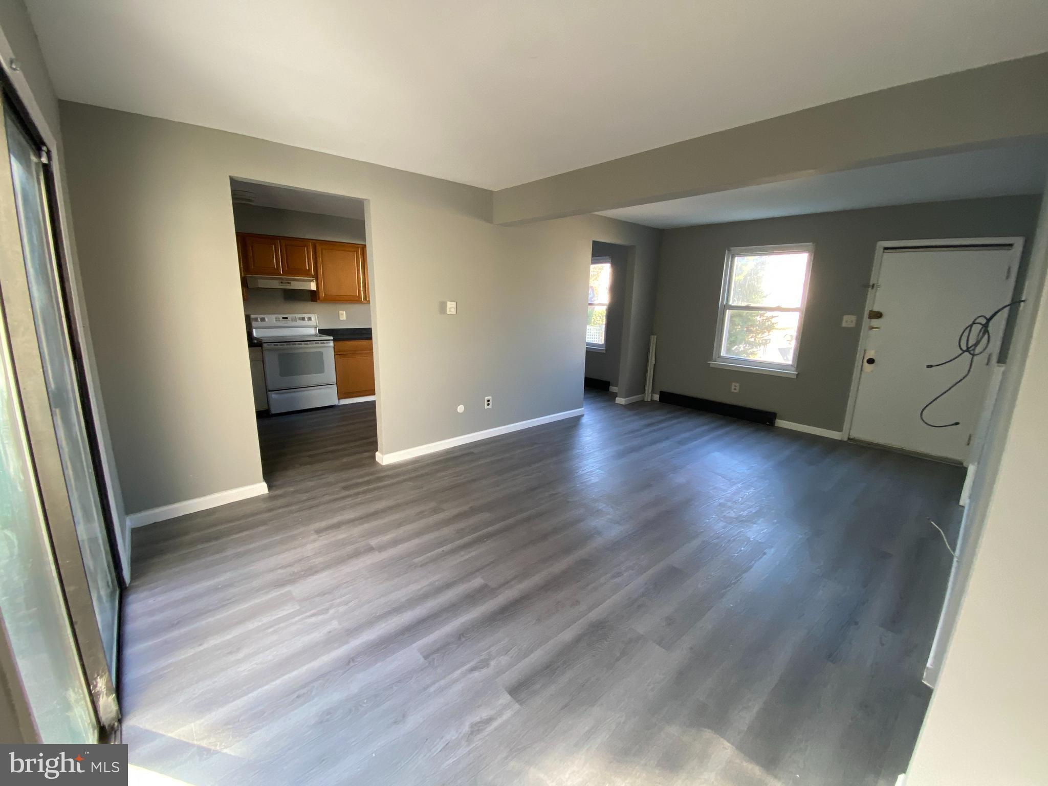 14 Berkshire Road Sicklerville, NJ 08081 - Photo 3 of 17 an empty room with wooden floor and windows