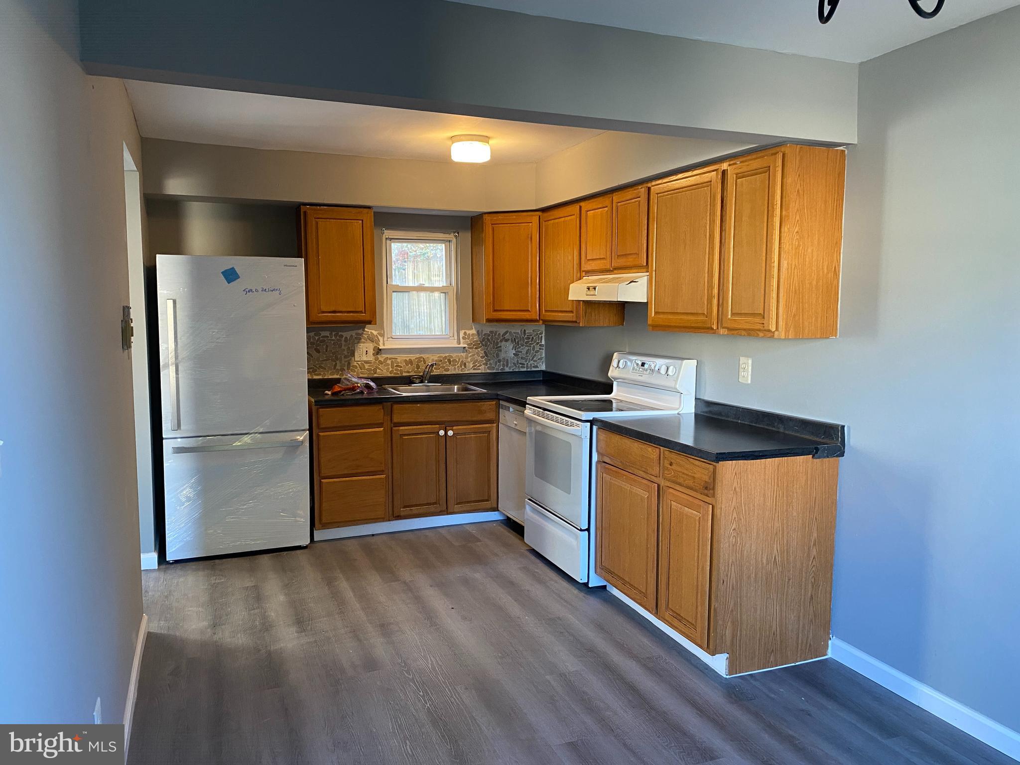 14 Berkshire Road Sicklerville, NJ 08081 - Photo 5 of 17 a kitchen with granite countertop stainless steel appliances a sink a counter space and cabinets