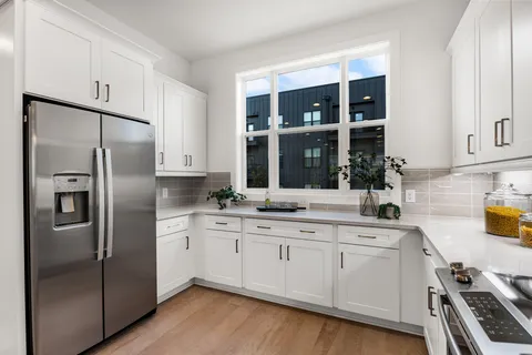 a kitchen with stainless steel appliances a refrigerator sink and cabinets