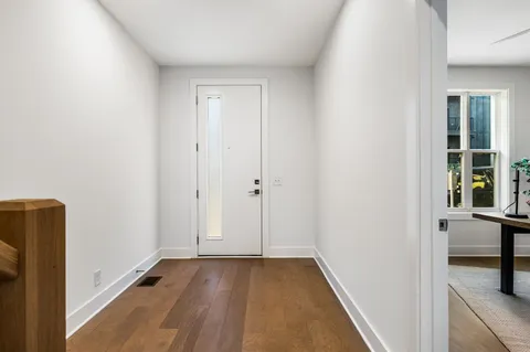a view of a room with wooden floor and a sink