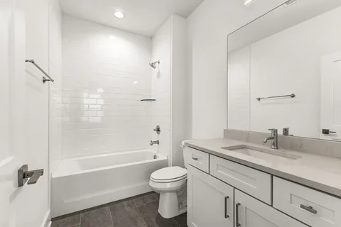 a bathroom with a sink a toilet and a bathtub