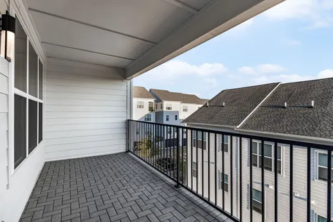 a view of a balcony with wooden floor