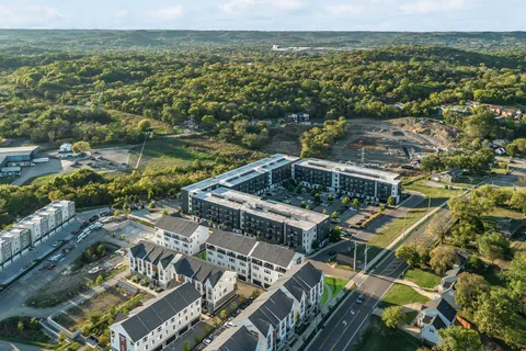 an aerial view of a house with yard swimming pool and outdoor seating
