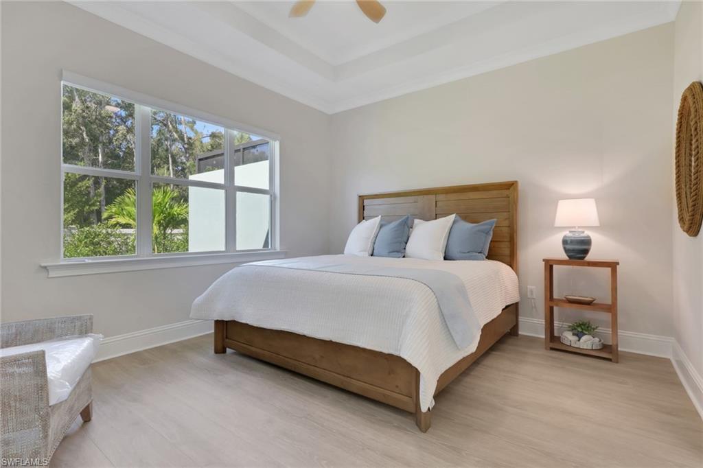 8861 Yucatan Court Naples, FL 34113 - Photo 12 of 39 a bed sitting in a bedroom next to a window