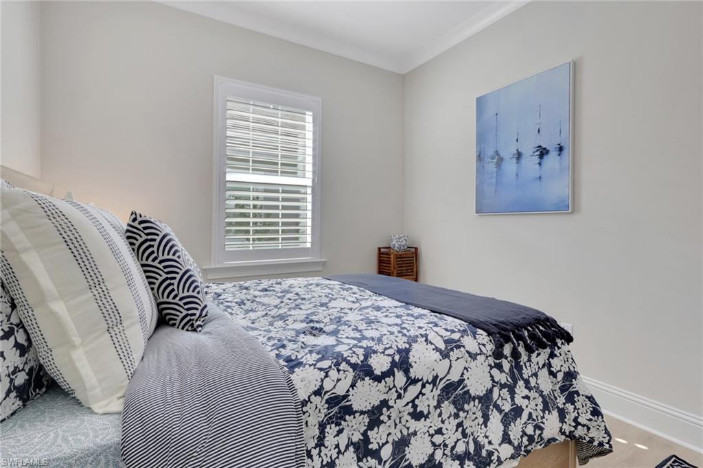 8861 Yucatan Court Naples, FL 34113 - Photo 16 of 39 a bedroom with a bed and a painting on the wall