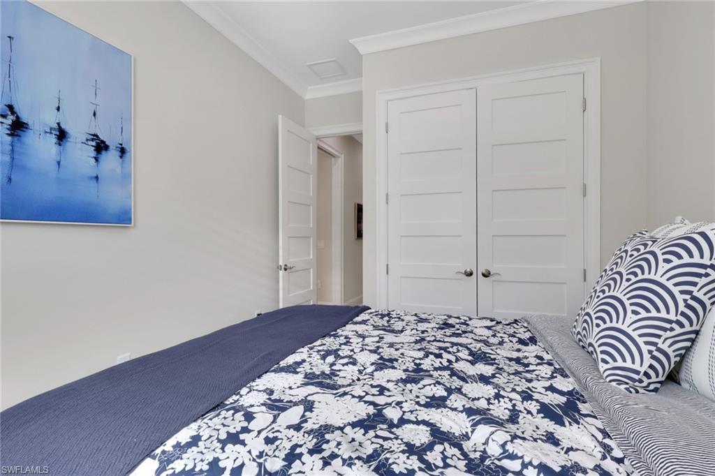 8861 Yucatan Court Naples, FL 34113 - Photo 17 of 39 a large bed in a white bedroom