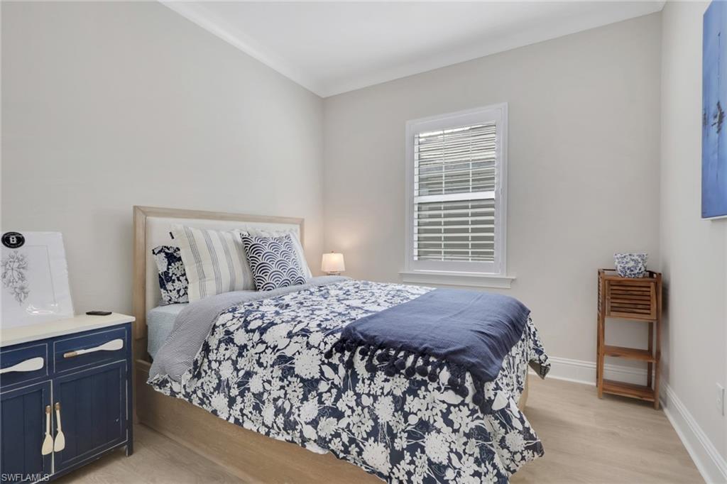 8861 Yucatan Court Naples, FL 34113 - Photo 18 of 39 a bedroom with a bed and a window