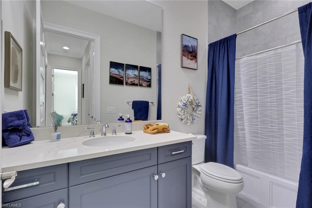 8861 Yucatan Court Naples, FL 34113 - Photo 19 of 39 a bathroom with a sink and a mirror with toilet