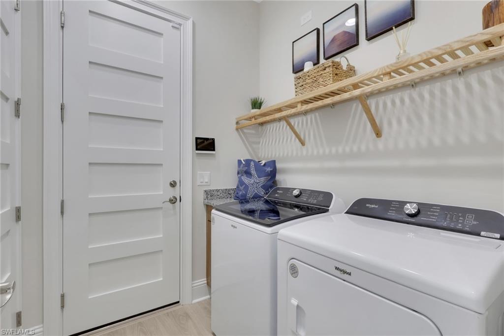 8861 Yucatan Court Naples, FL 34113 - Photo 21 of 39 a utility room with dryer and washer