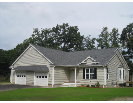 14 Reed Lane, Unit 14 Littleton, MA 01460 - Photo 1 of 12 a front view of a house with a yard and trees