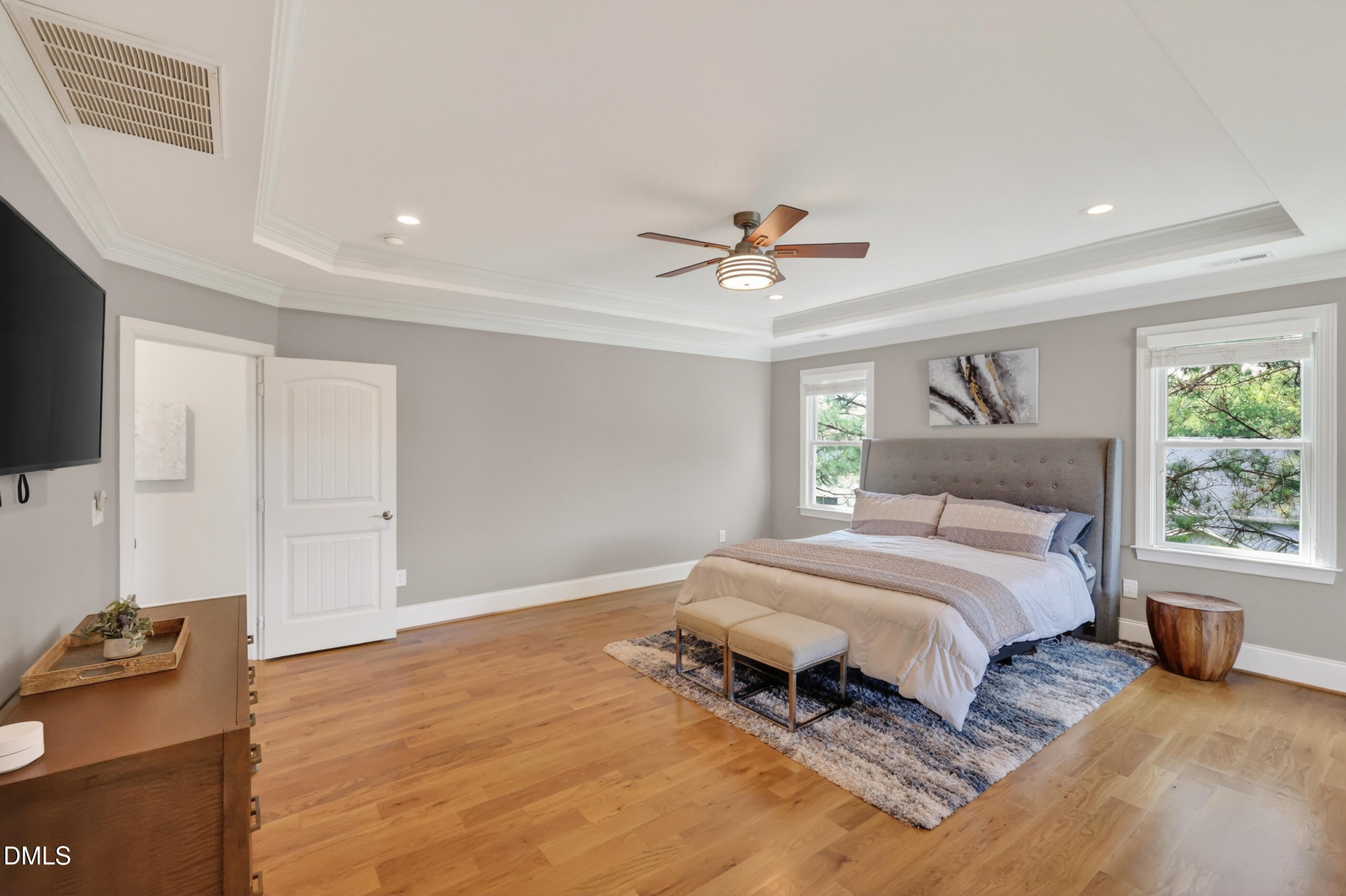 261 Character Drive Rolesville, NC 27571 - Photo 34 of 77 a spacious bedroom with a bed and a flat screen tv
