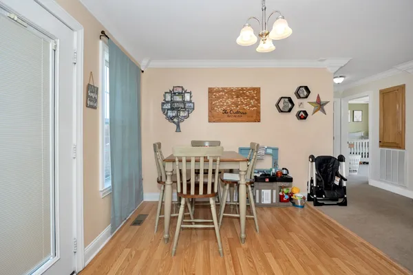 a view of a dining room with furniture and wooden floor