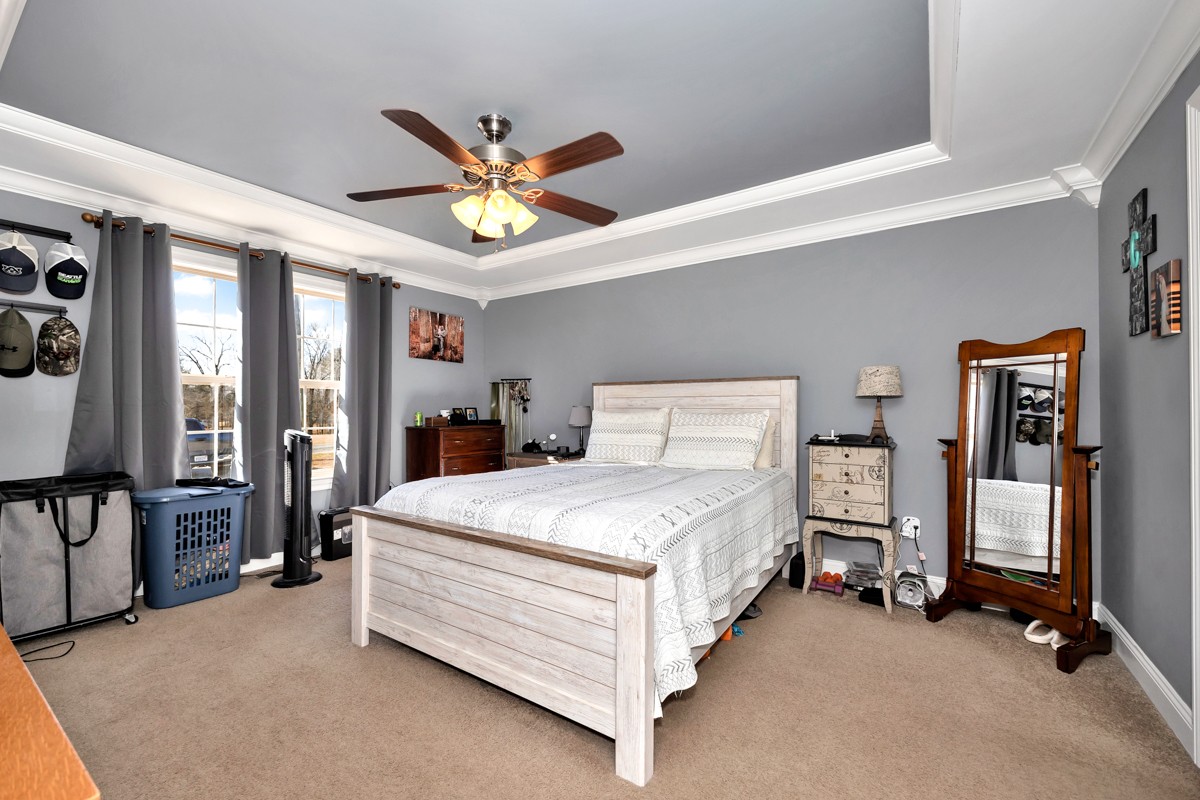 27474 North Wales Road Elkmont, AL 35620 - Photo 19 of 30 a spacious bedroom with a bed and a chandelier