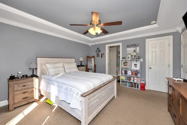 a bedroom with a bed and a chandelier