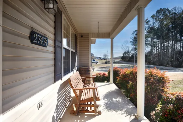 a view of balcony with wooden floor and outdoor seating