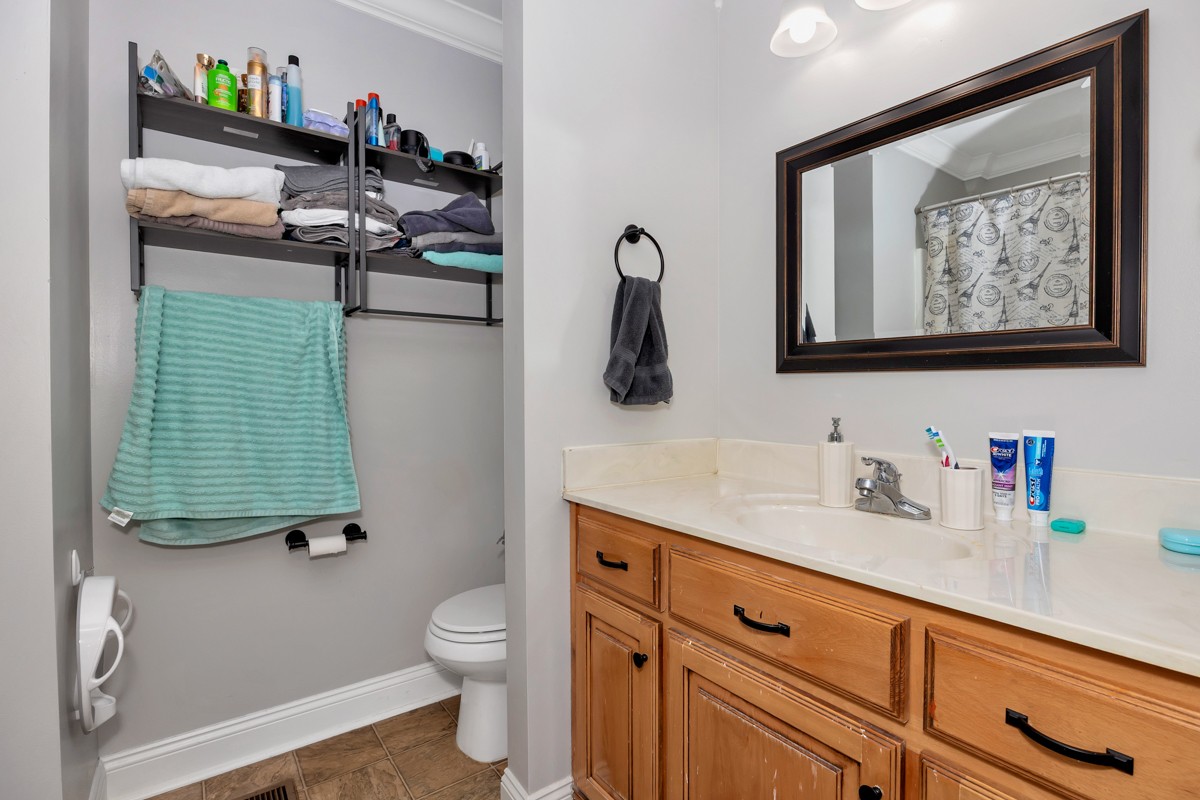 27474 North Wales Road Elkmont, AL 35620 - Photo 21 of 30 a bathroom with a toilet sink and mirror