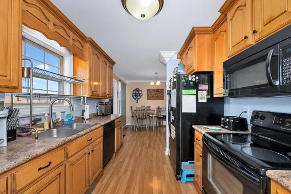 a kitchen with stainless steel appliances granite countertop a stove a sink and a refrigerator