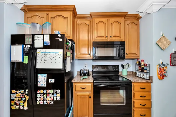 a kitchen with stainless steel appliances granite countertop a stove and cabinets