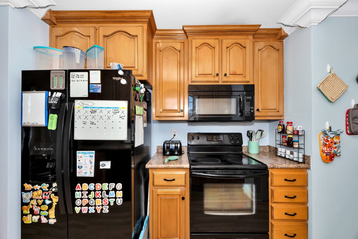 27474 North Wales Road Elkmont, AL 35620 - Photo 9 of 30 a kitchen with stainless steel appliances granite countertop a stove and cabinets