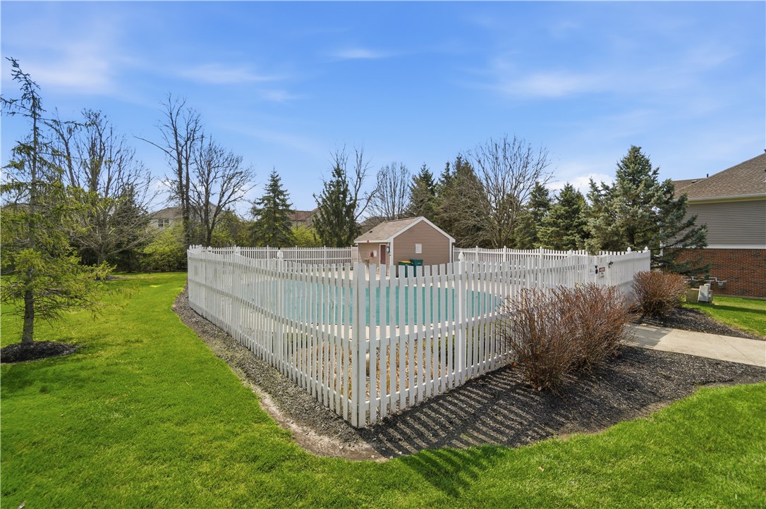 4294 Straight Arrow Road Dayton, OH 45430 - Photo 41 of 41 This inviting community pool offers a refreshing escape surrounded by lush greenery and a charming fence.
