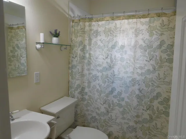 a view of a small space with wooden floor and a window