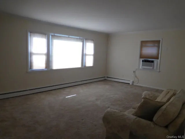 a living room with furniture and windows