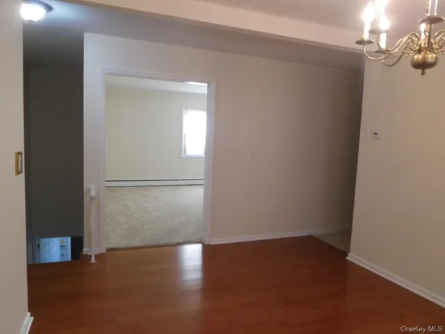 a view of a room with wooden floor and cabinet